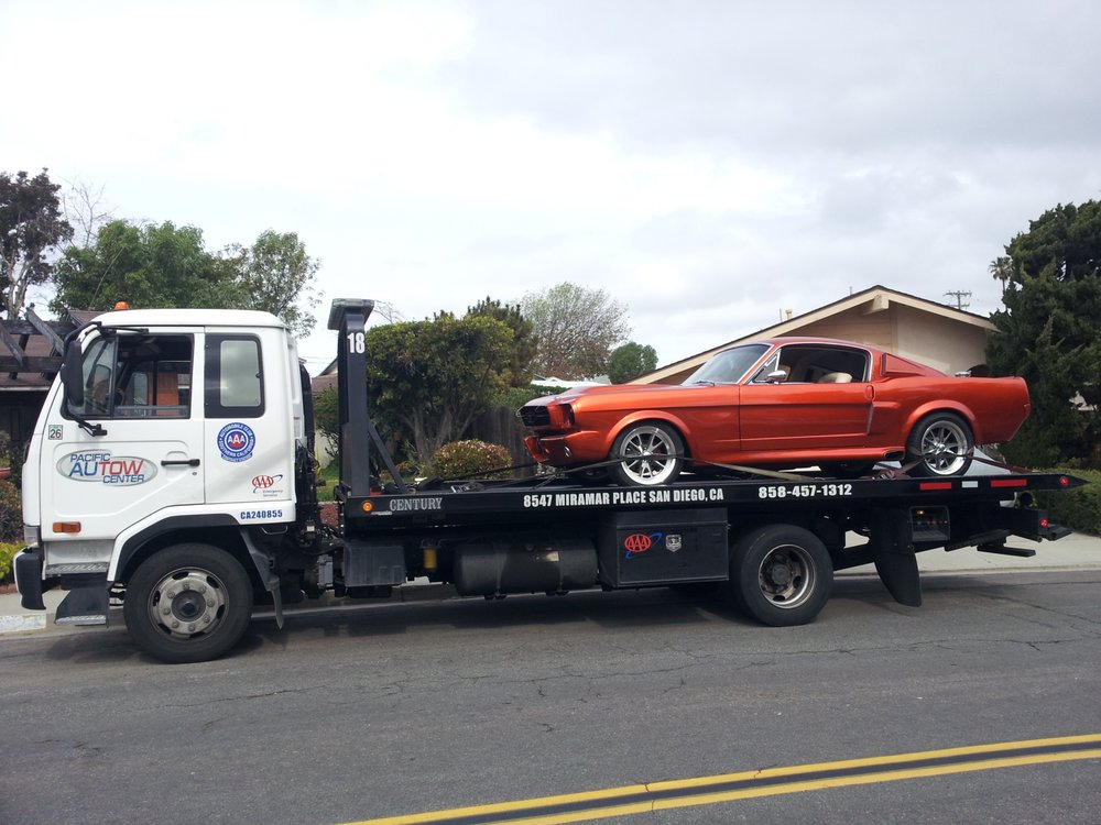 red car on tow truck