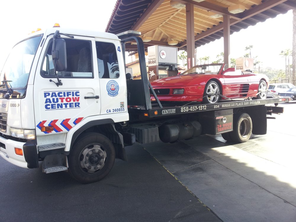 red car on tow truck