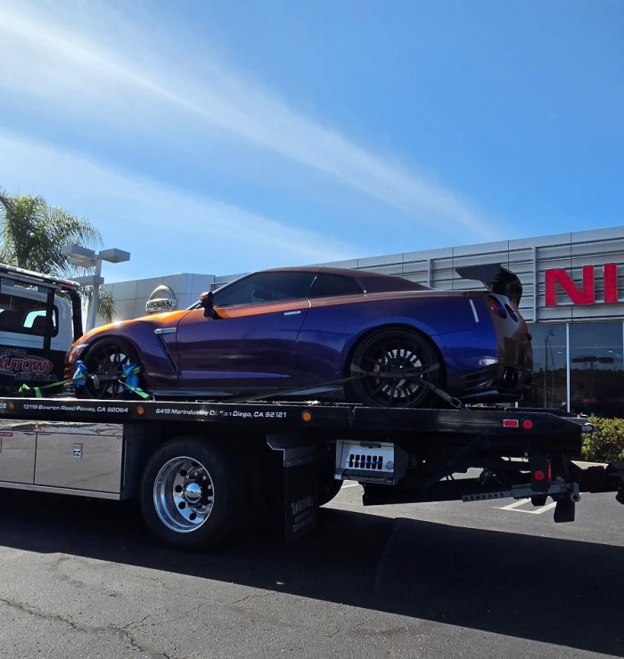 Pacific Autow tow truck loading a car in San Diego